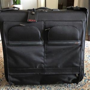 TUMI garment luggage. 24” x 24” x 14 (folded)  color black. Wheels